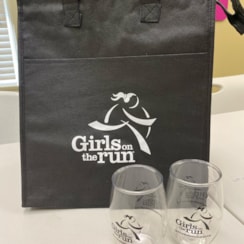 wine glasses cheersing on checkered table cloth with Dinner on the Run logo